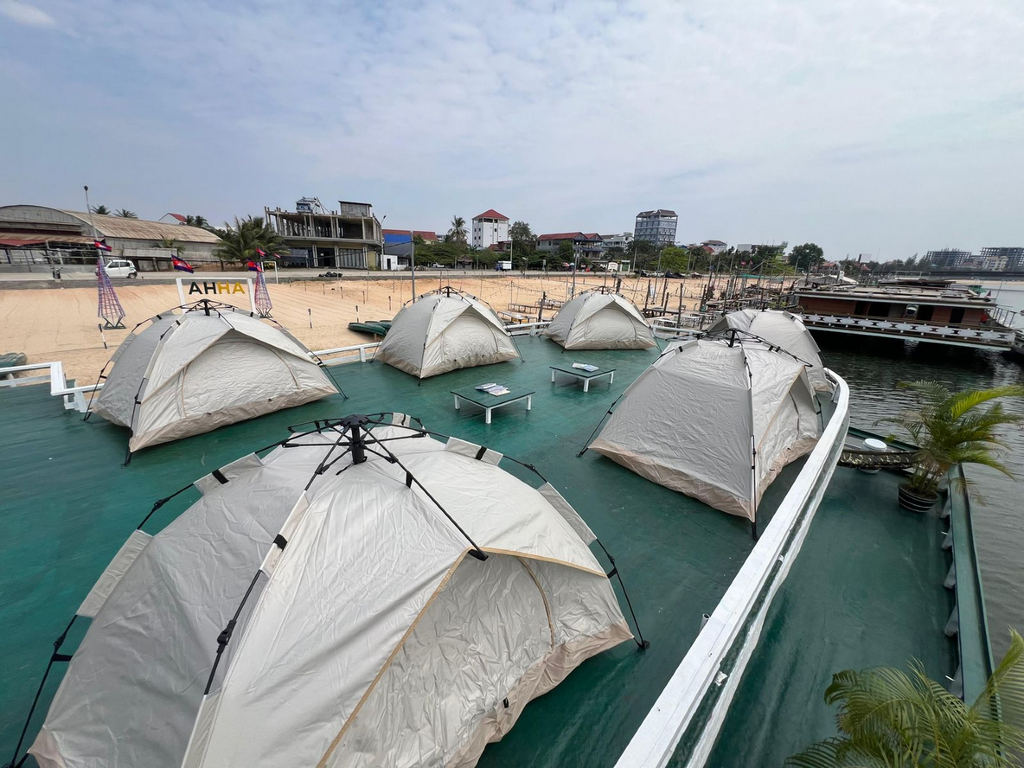 AHHA Floatel Library, hammocks, tents, cafe, kayaks on the Kampot River in Cambodia.